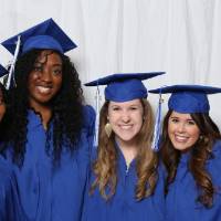 Four graduates pose together at GradFest